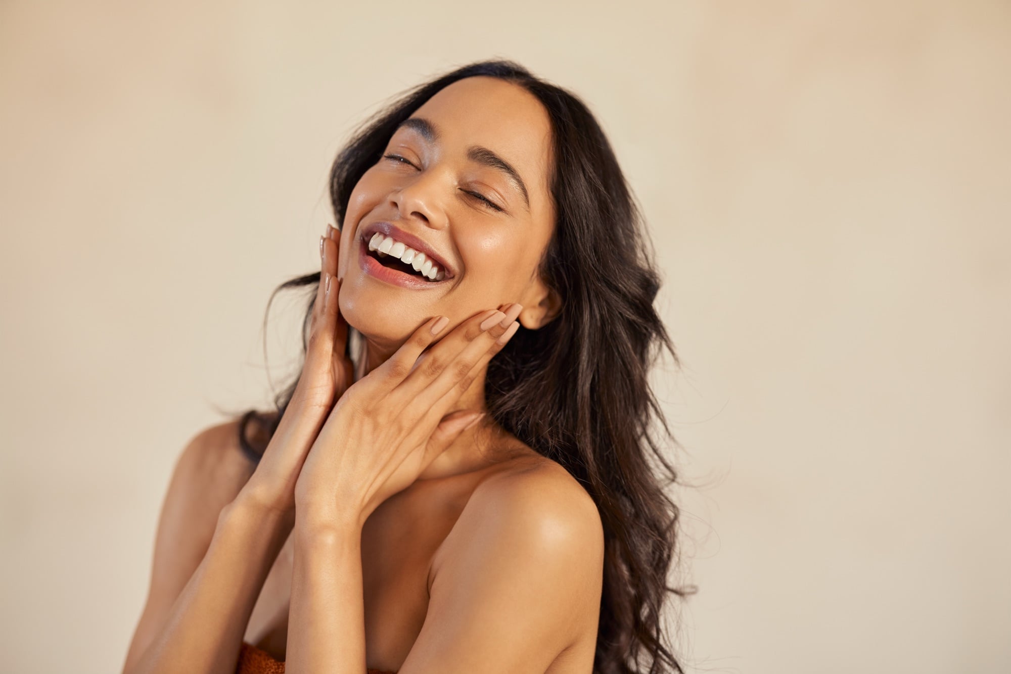 A woman laughing with a bright, healthy smile