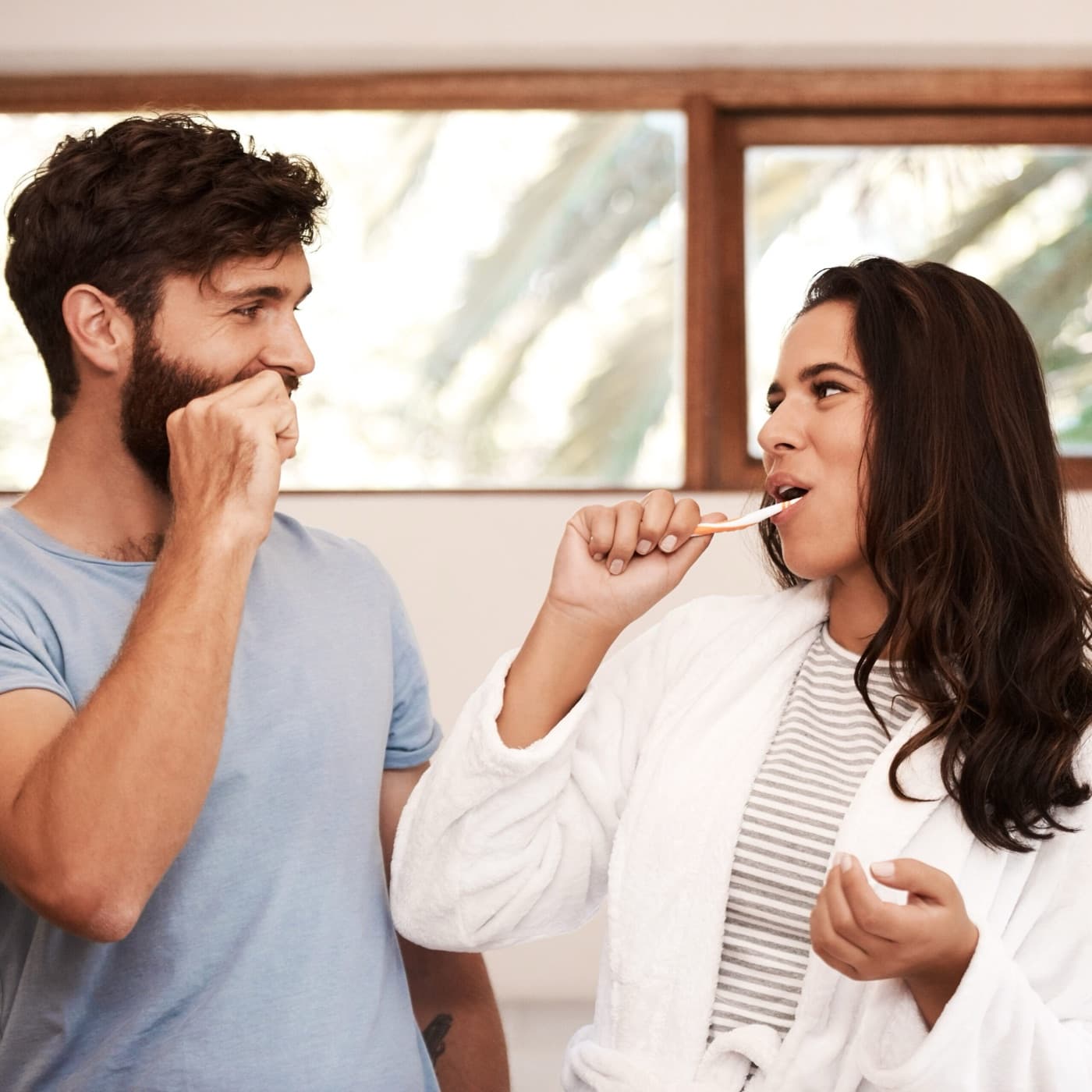 Two patients brushing their teeth together at home
