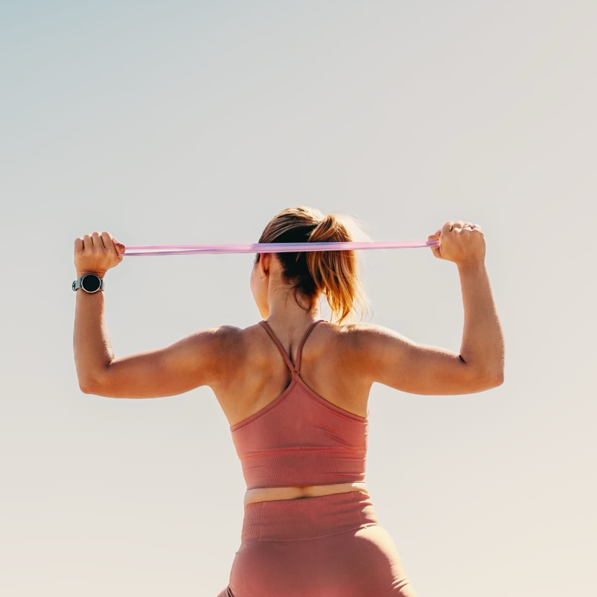 Person stretching outdoors at sunrise