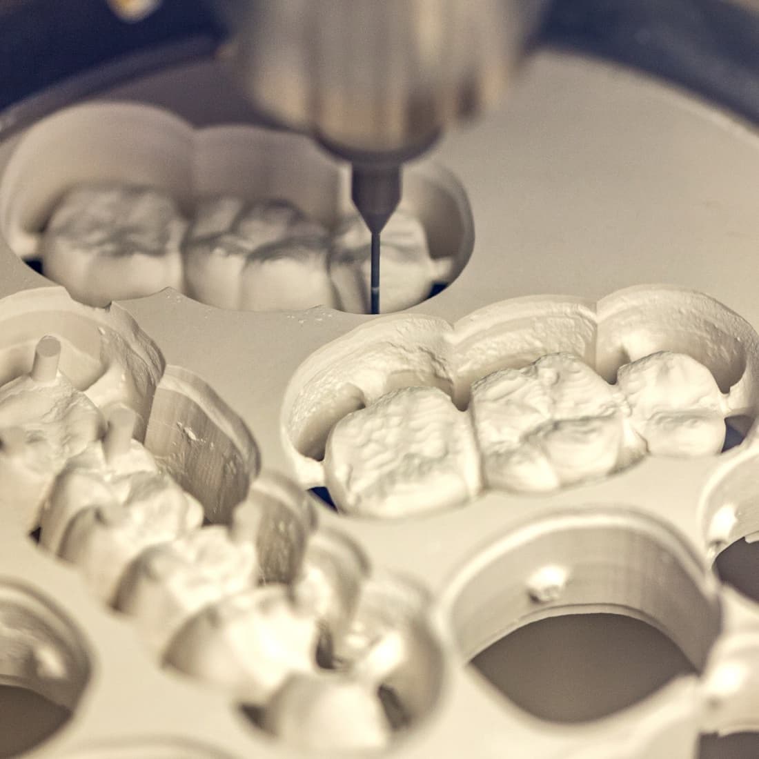 Milling unit shaping ceramic crowns in the in-house lab